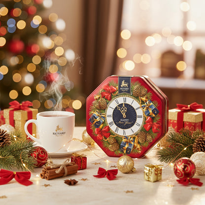 Decorative clock with Christmas theme on a table with a cup of tea and festive decorations.