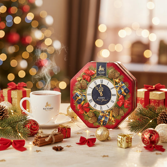 Decorative clock with Christmas theme on a table with a cup of tea and festive decorations.